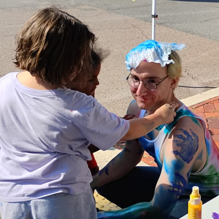 Garrett Webb being painted by local children in the name of preventing them from painting themselves.